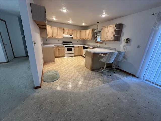 an empty room with windows and cabinet