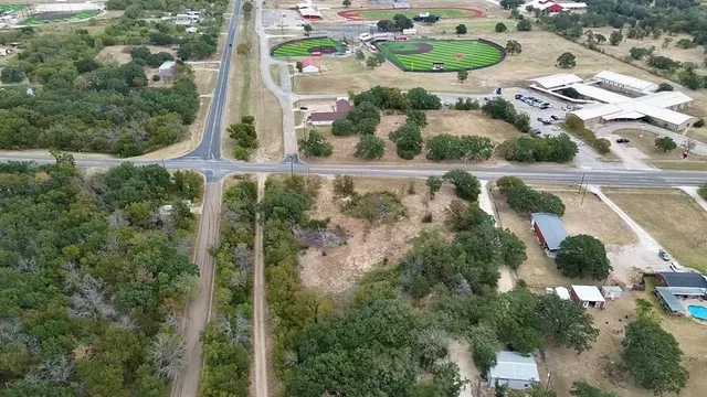 an aerial view of a residential houses with outdoor space