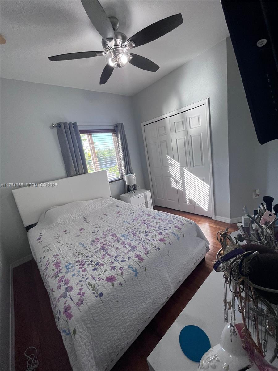 22937 Southwest 9th Avenue, Unit 1 Miami, FL 33170 - Photo 14 of 19 a bedroom with a bed and dresser with mirror