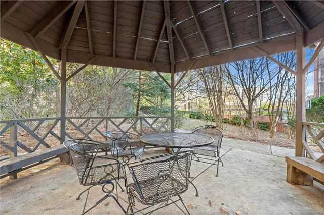 a patio with a yard table and chairs