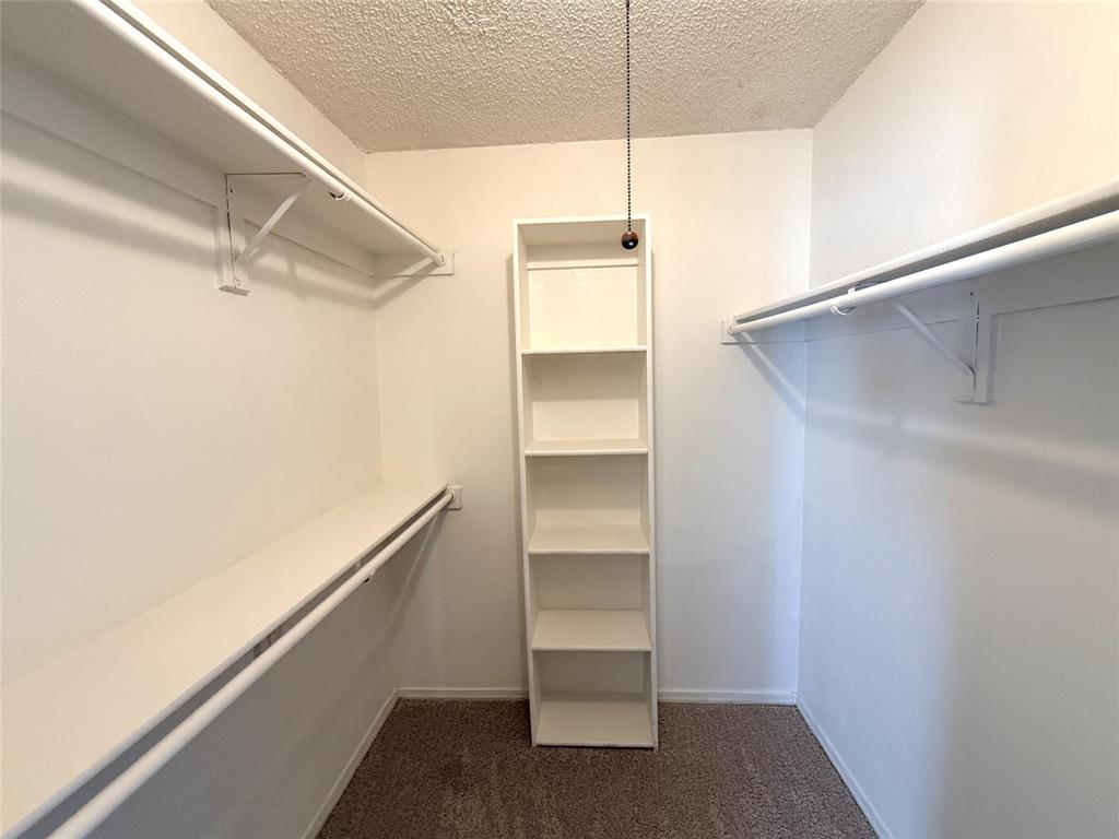 4243 Timberglen Road Dallas, TX 75287 - Photo 11 of 16 a view of an empty walk in closet
