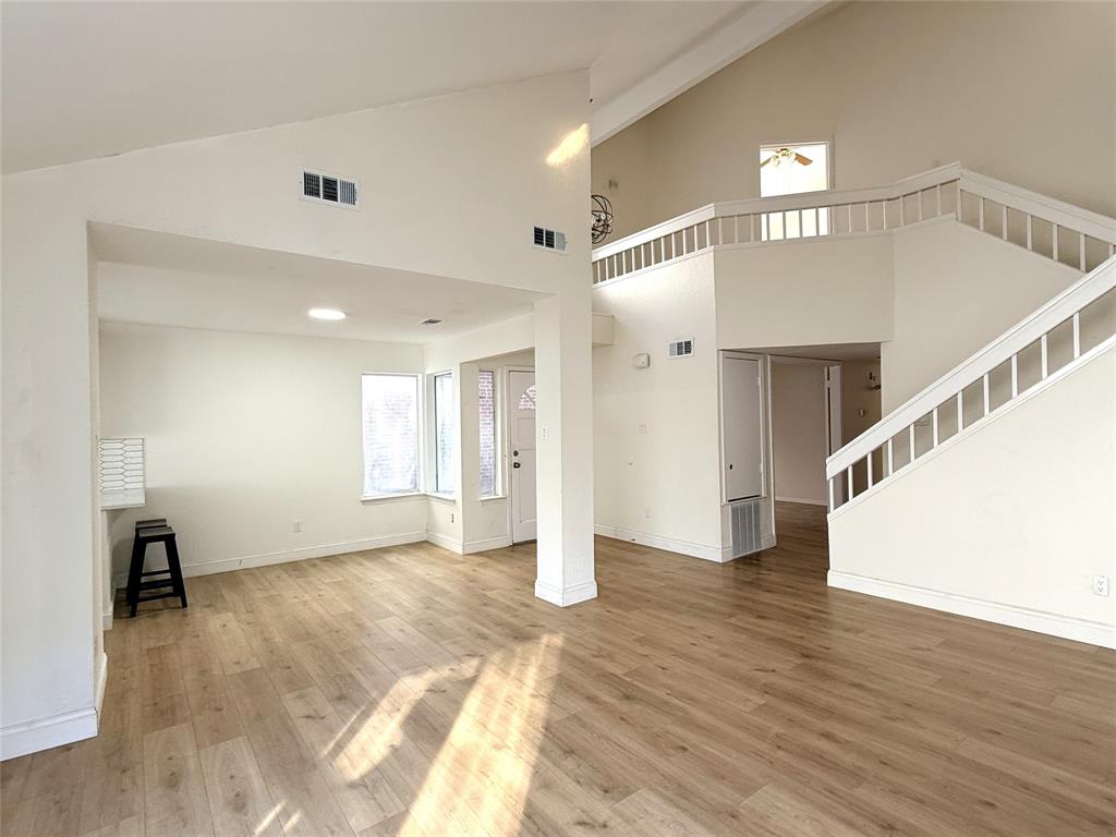 4243 Timberglen Road Dallas, TX 75287 - Photo 14 of 16 a view of an empty room with wooden floor