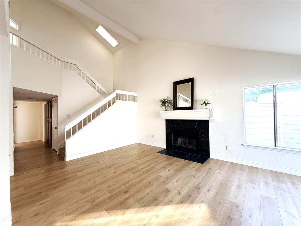 4243 Timberglen Road Dallas, TX 75287 - Photo 16 of 16 a view of empty room with wooden floor and fireplace
