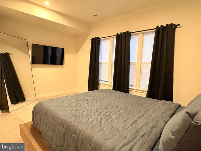 a bedroom with a bed and a flat screen tv