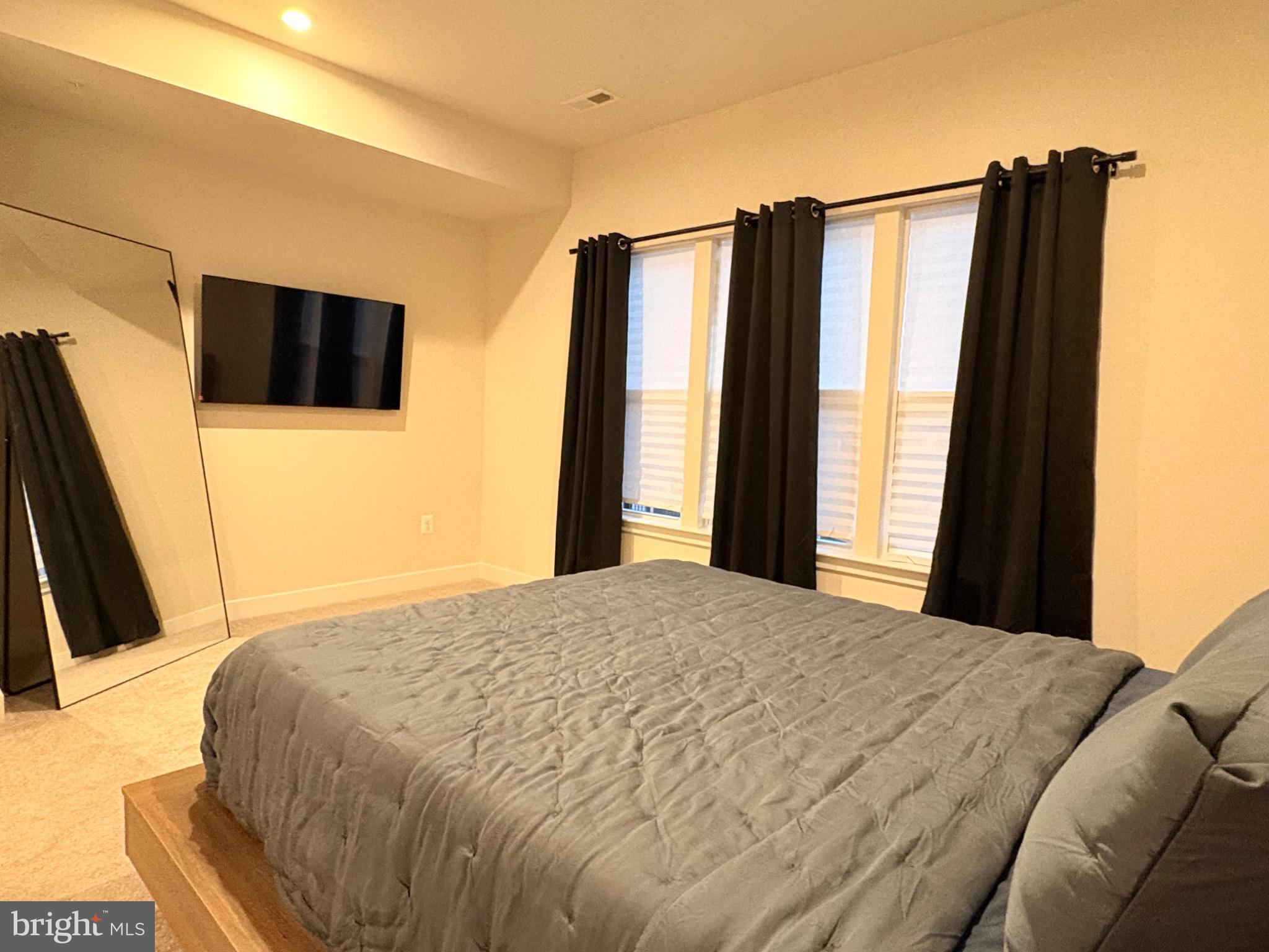 736 Watts Street Baltimore, MD 21217 - Photo 15 of 32 a bedroom with a bed and a flat screen tv