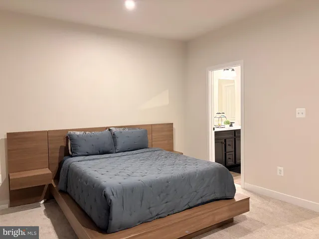a bedroom with a bed and a night stand