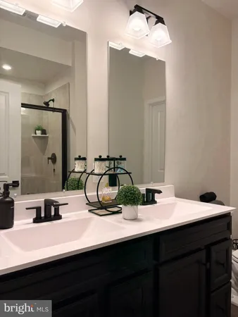 a bathroom with a double vanity sink and a mirror