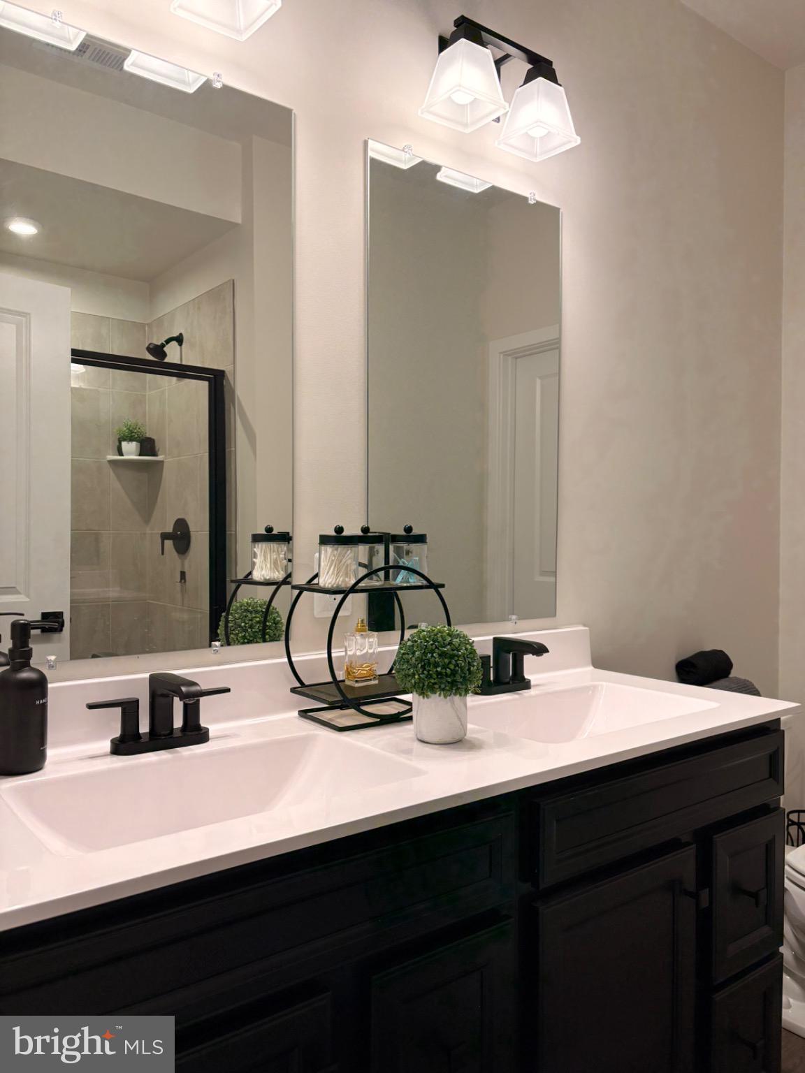 736 Watts Street Baltimore, MD 21217 - Photo 17 of 32 a bathroom with a double vanity sink and a mirror