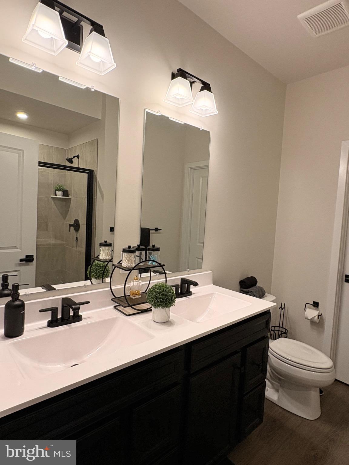 736 Watts Street Baltimore, MD 21217 - Photo 18 of 32 a bathroom with a sink a toilet and a mirror