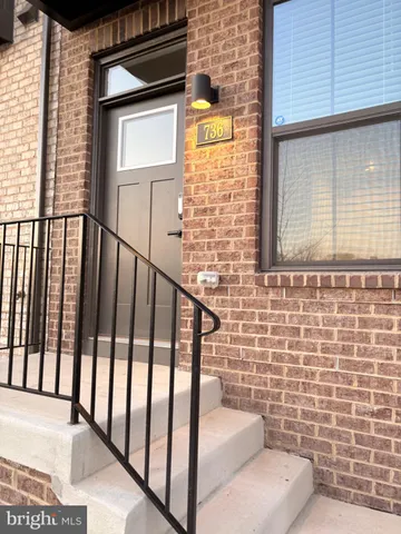 a view of a brick house with stairs and wooden floor