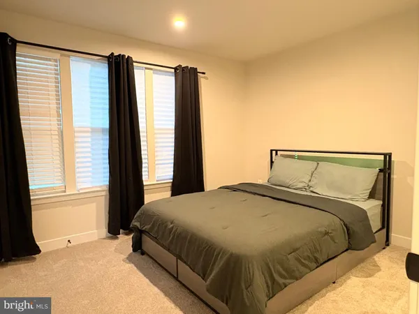a bedroom with a large bed and a window