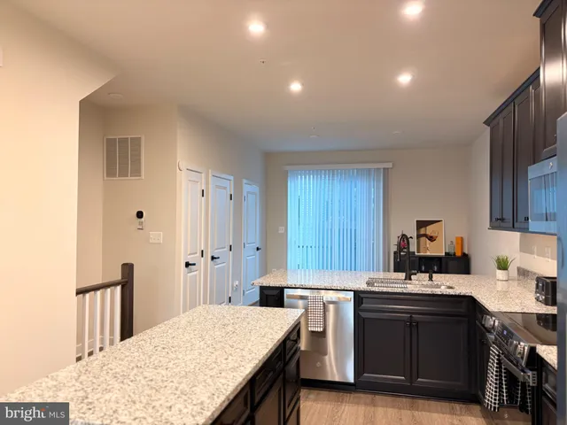 a kitchen with a sink stove and refrigerator