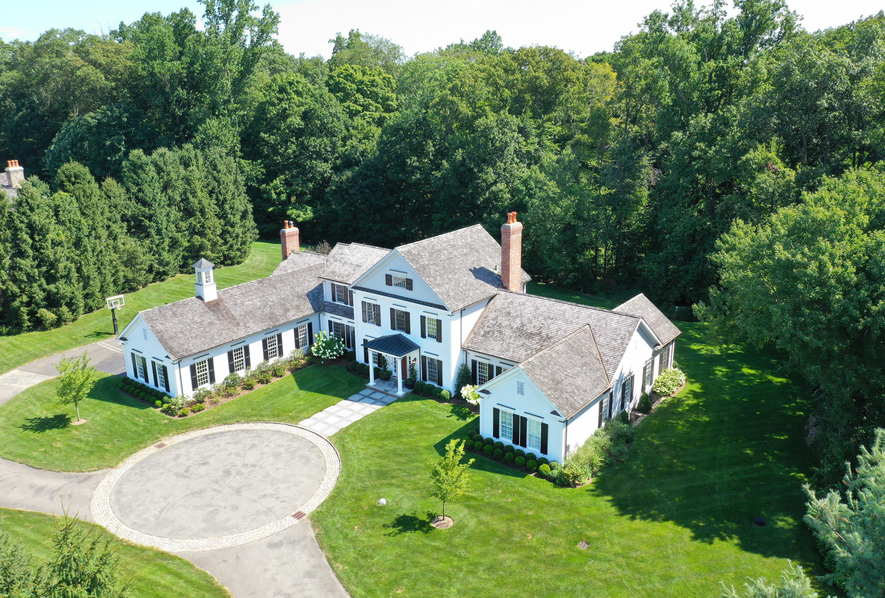 an aerial view of a house with a big yard