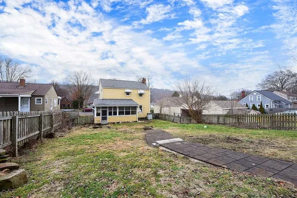 a view of residential houses with yard and entertaining space