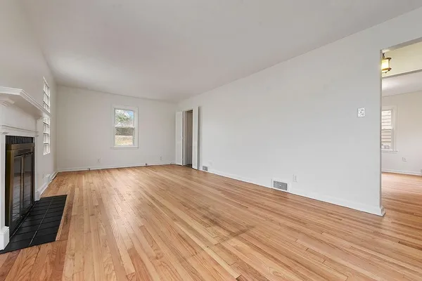 wooden floor in an empty room with a window