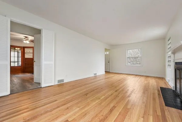 wooden floor in an empty room with a window