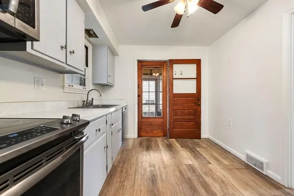 a kitchen with a stove oven and cabinets