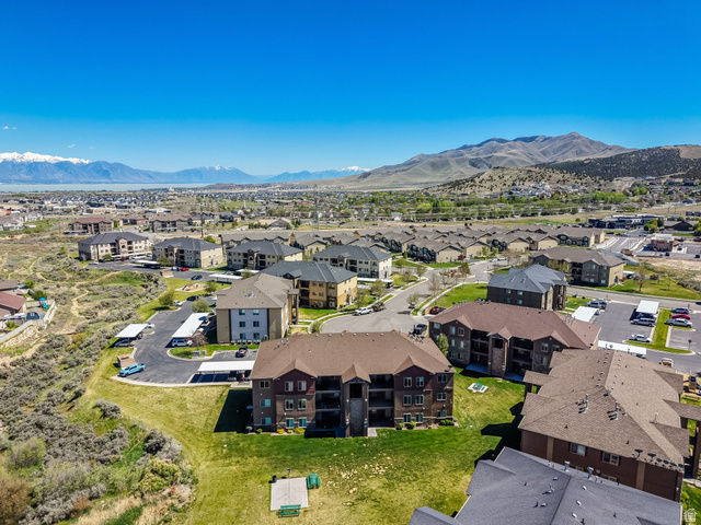 8215 Clear Rock Road, Unit 12 Eagle Mountain, UT 84005 - Photo 27 of 38 Expansive residential community featuring multiple multi-story buildings with brown and grey roofs