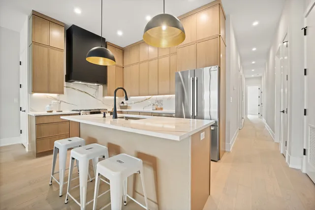 a kitchen with stainless steel appliances a sink stove and refrigerator
