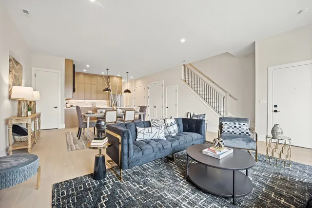 a living room with furniture and a dining table