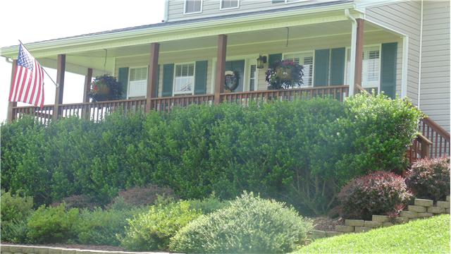 2083 Chester Harris Road Woodlawn, TN 37191 - Photo 3 of 15 Nice landscaping to look upon from the covered porch