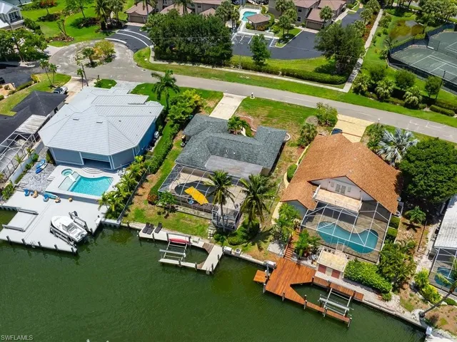 an aerial view of a house with a garden and swimming pool