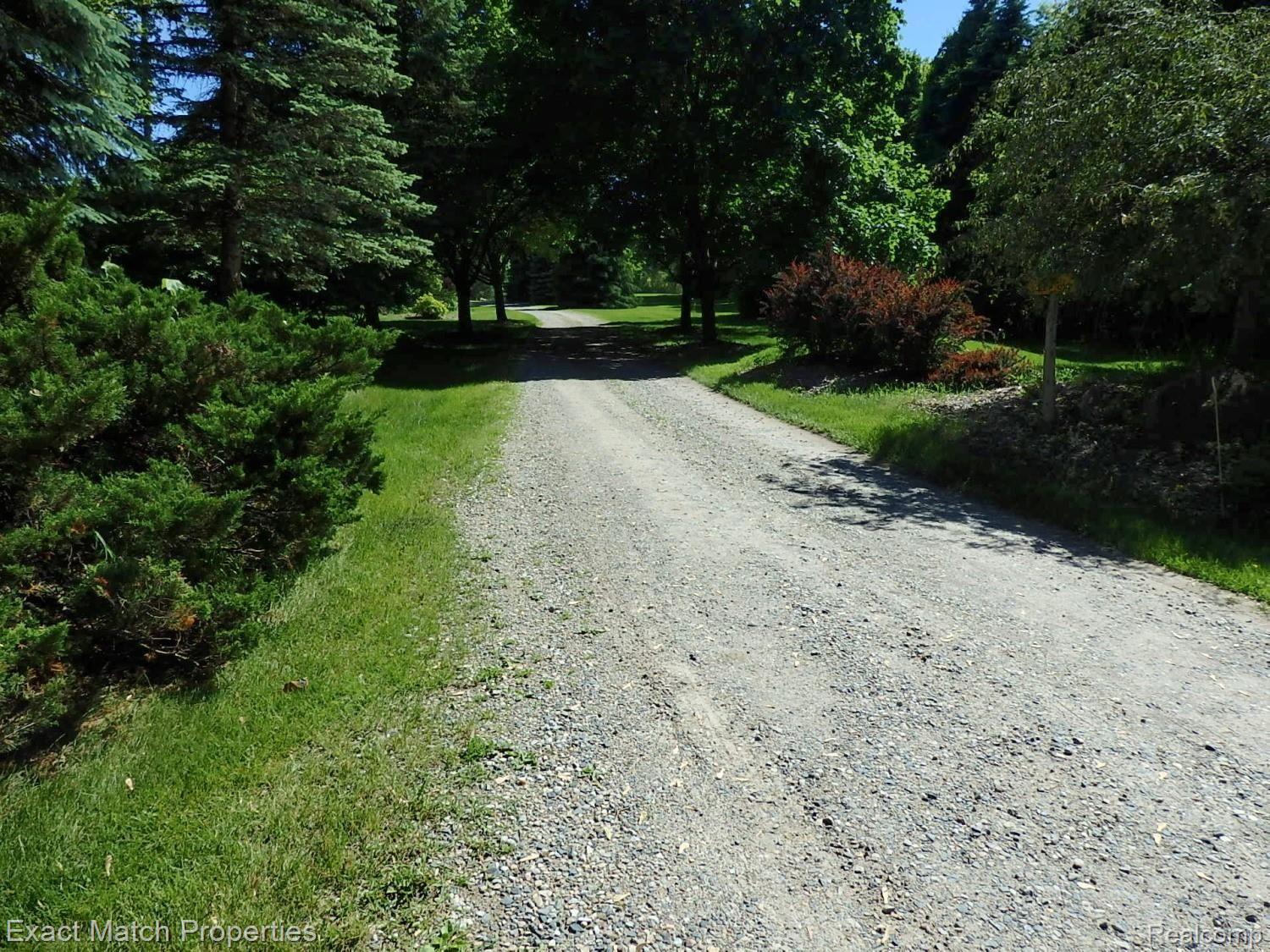 Shared driveway leads back to the property.