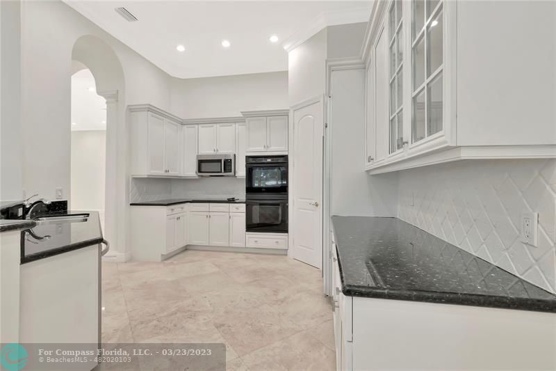 15865 Double Eagle Trail Delray Beach, FL 33446 - Photo 13 of 71 a large kitchen with cabinets