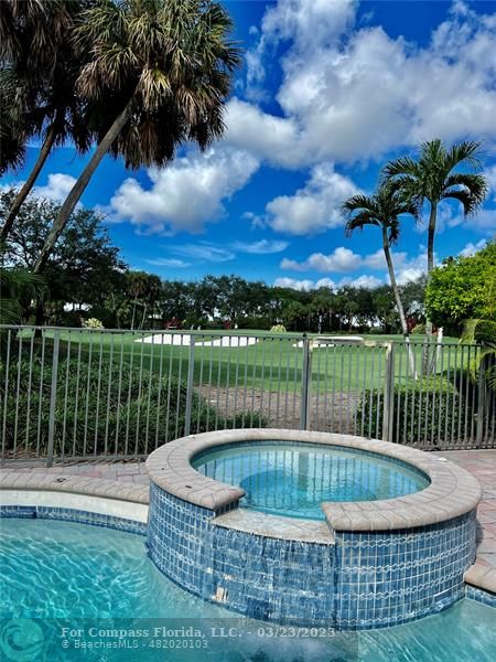 15865 Double Eagle Trail Delray Beach, FL 33446 - Photo 17 of 71 a view of a swimming pool with a couches chairs and a yard