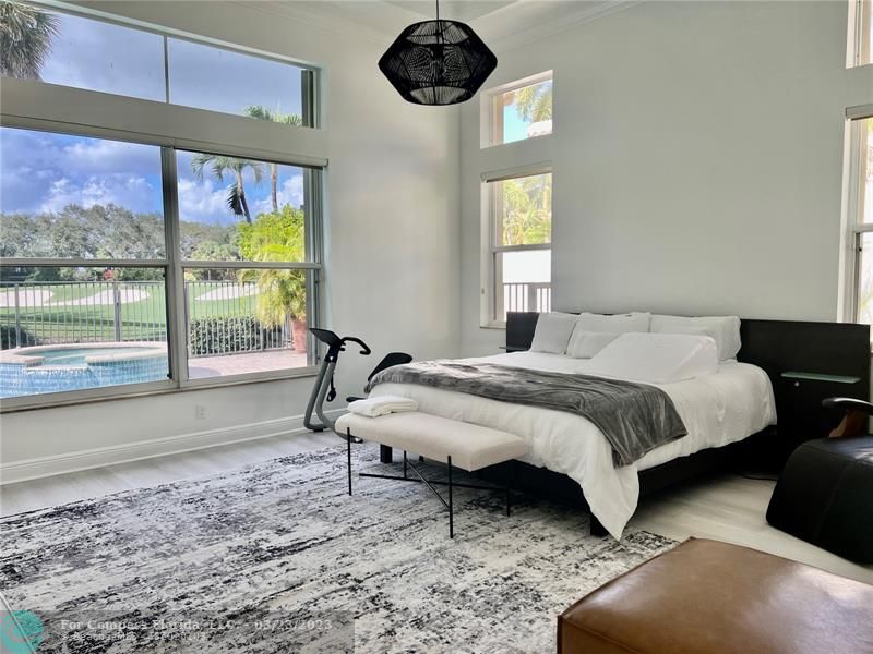 15865 Double Eagle Trail Delray Beach, FL 33446 - Photo 2 of 71 a bed sitting in a bedroom next to a window