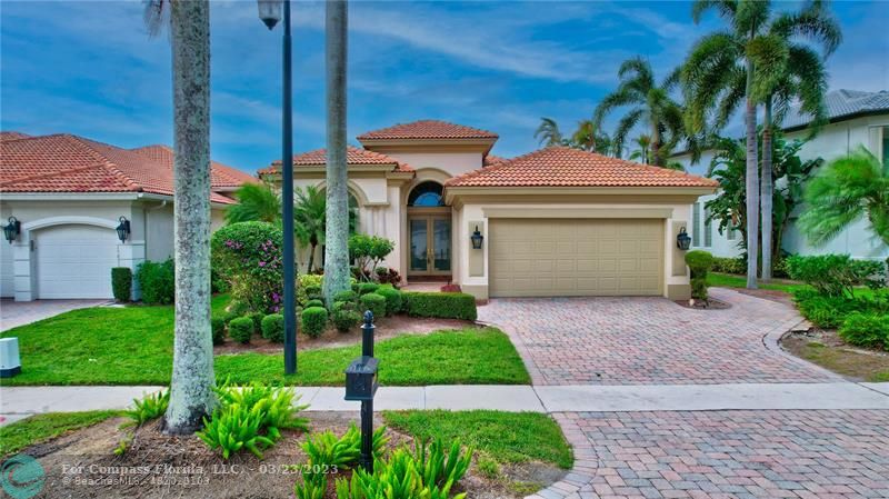 15865 Double Eagle Trail Delray Beach, FL 33446 - Photo 22 of 71 a front view of a house with a yard and potted plants