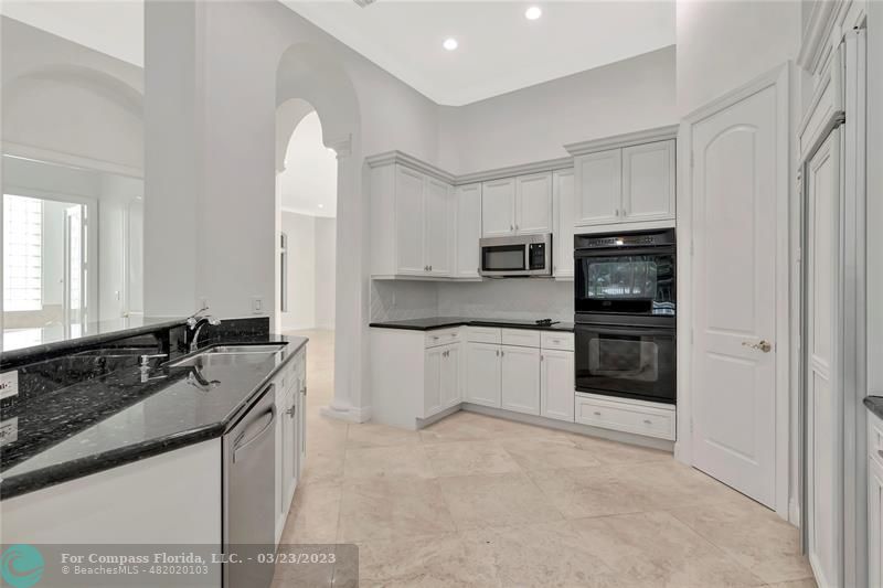 15865 Double Eagle Trail Delray Beach, FL 33446 - Photo 24 of 71 a kitchen with stainless steel appliances granite countertop a sink stove and refrigerator