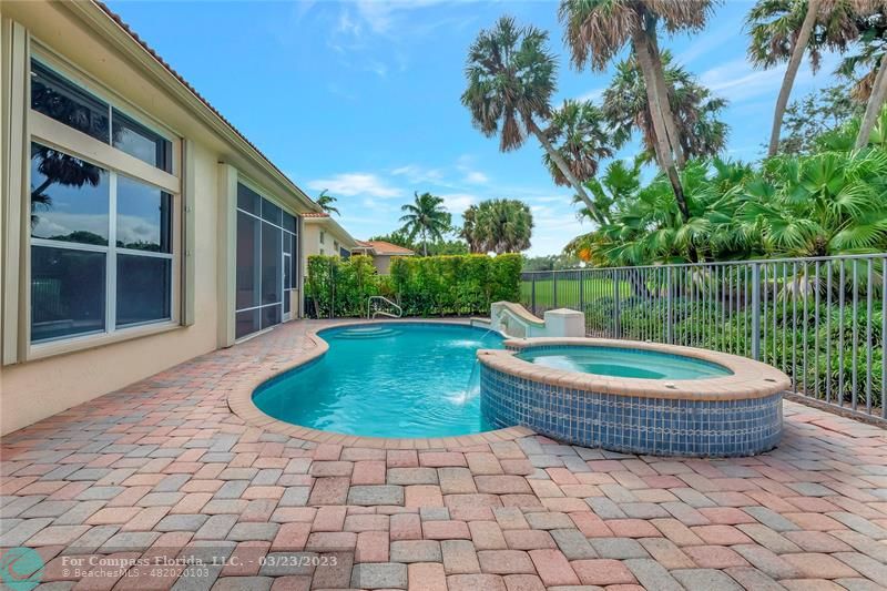 15865 Double Eagle Trail Delray Beach, FL 33446 - Photo 26 of 71 a backyard of a house with fountain table and chairs