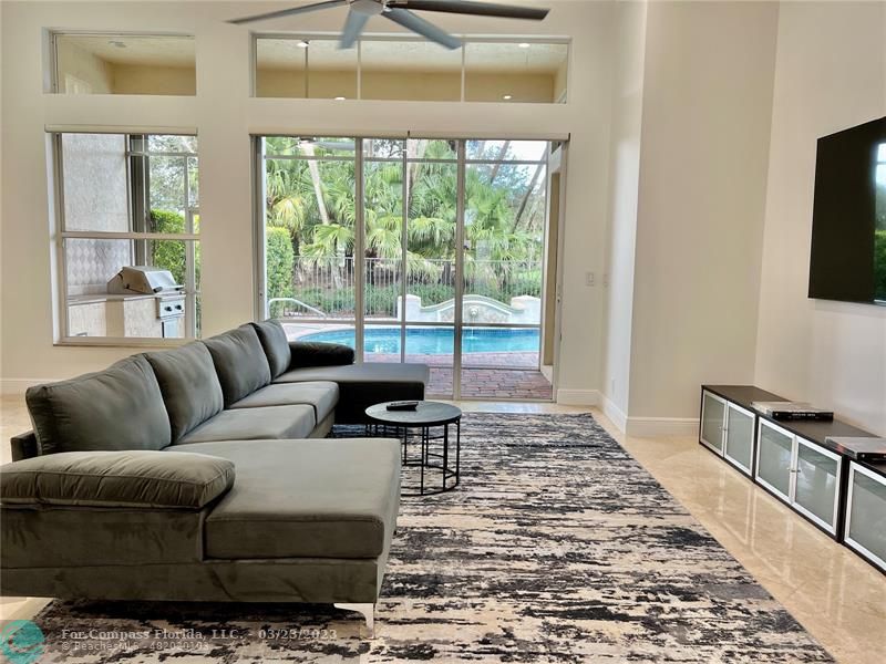 15865 Double Eagle Trail Delray Beach, FL 33446 - Photo 4 of 71 a living room with furniture and a flat screen tv