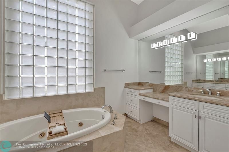 15865 Double Eagle Trail Delray Beach, FL 33446 - Photo 43 of 71 a bathroom with a tub sink and mirror