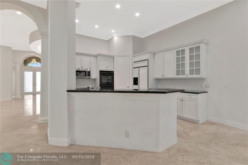 15865 Double Eagle Trail Delray Beach, FL 33446 - Photo 6 of 71 a kitchen with stainless steel appliances granite countertop a refrigerator and a stove