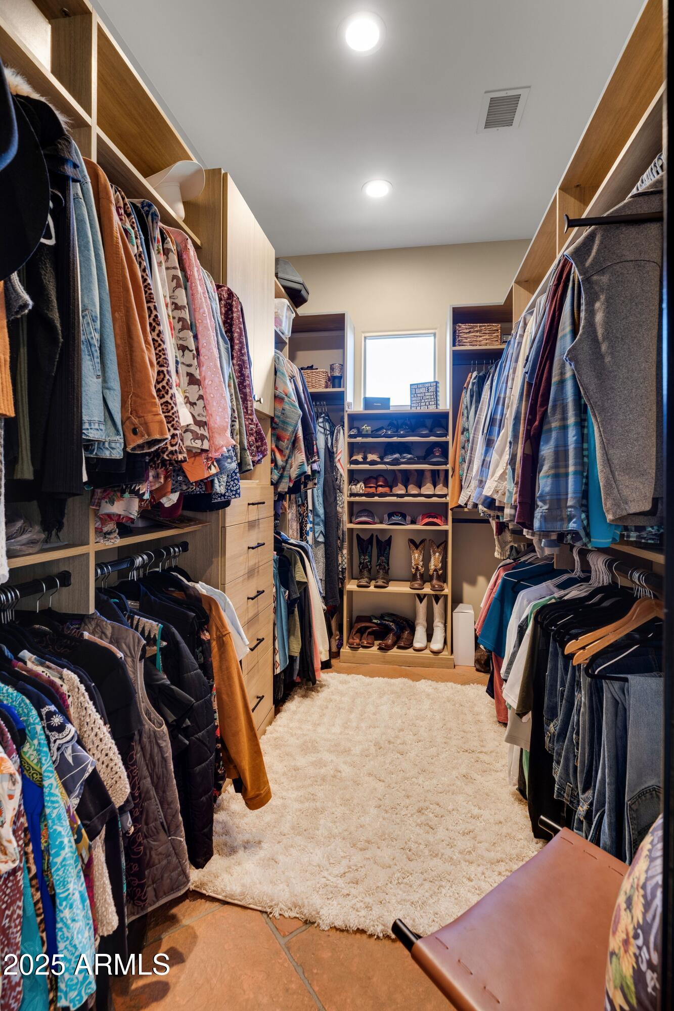 14224 East Rockview Road Scottsdale, AZ 85262 - Photo 35 of 118 a view of walk in closet with clothes and shoes