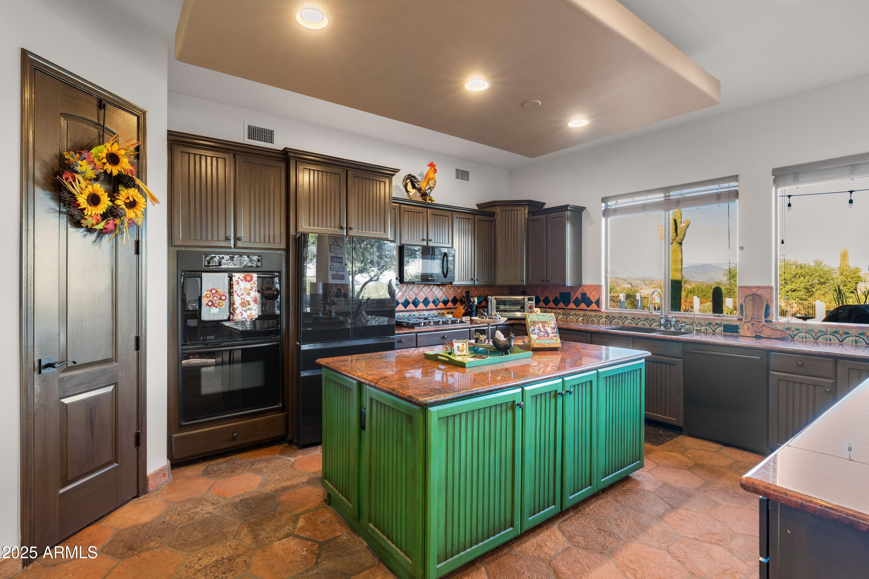 14224 East Rockview Road Scottsdale, AZ 85262 - Photo 4 of 118 a kitchen with stainless steel appliances granite countertop a sink and a refrigerator