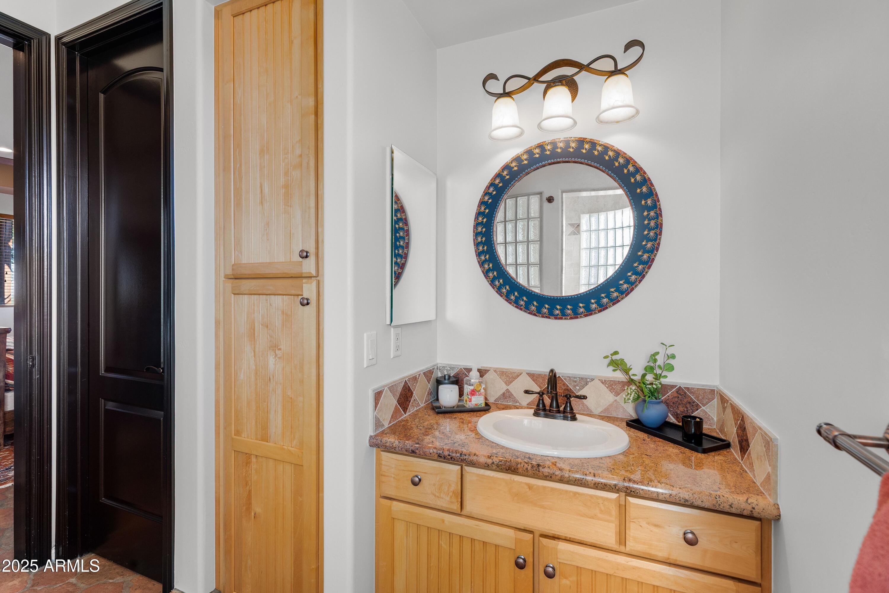 14224 East Rockview Road Scottsdale, AZ 85262 - Photo 42 of 118 a bathroom with a granite countertop sink and a mirror