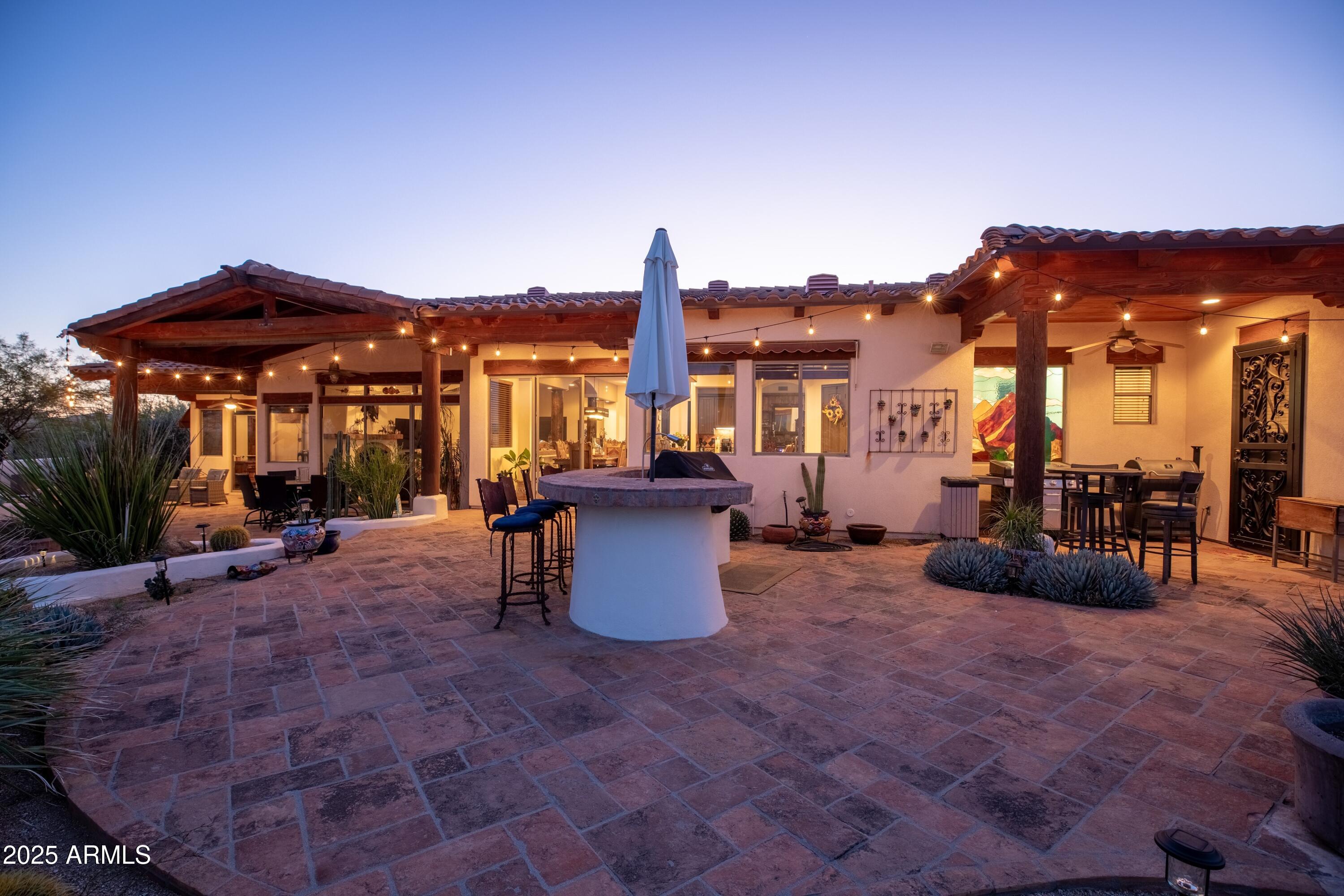 14224 East Rockview Road Scottsdale, AZ 85262 - Photo 55 of 118 a view of a patio with a table and chairs under an umbrella