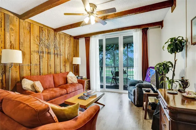 a living room with furniture a table and a potted plant