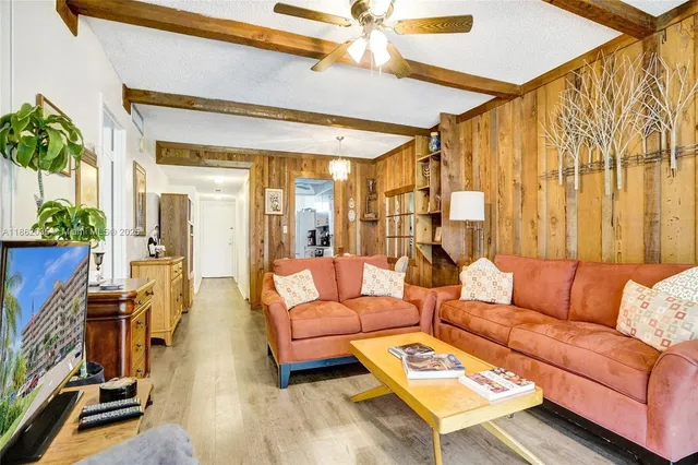 a living room with furniture a fireplace and a potted plant