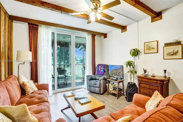 a living room with furniture a rug and a window