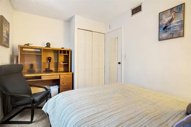 a bedroom with a bed and a desk