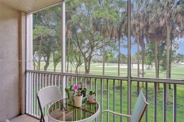 a view of a chair and table in the balcony