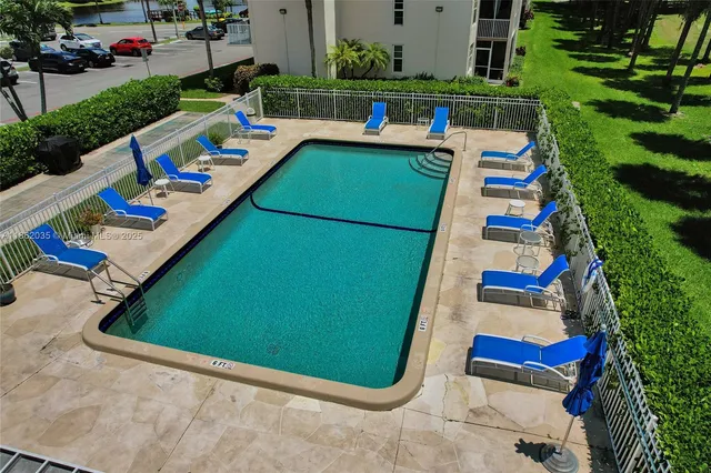 swimming pool view with couple of chairs in patio
