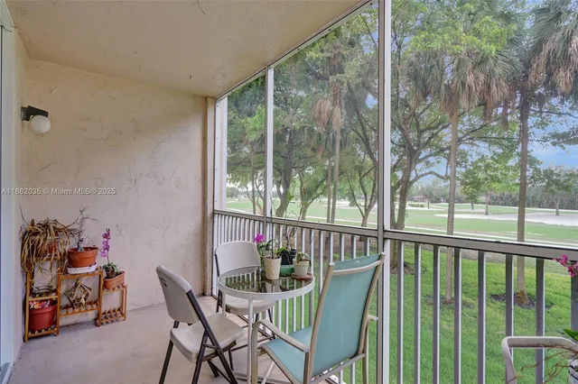 a view of a porch with furniture and garden view