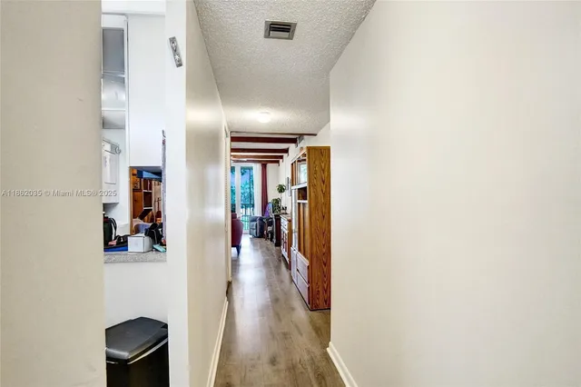 a view of hallway with wooden floor