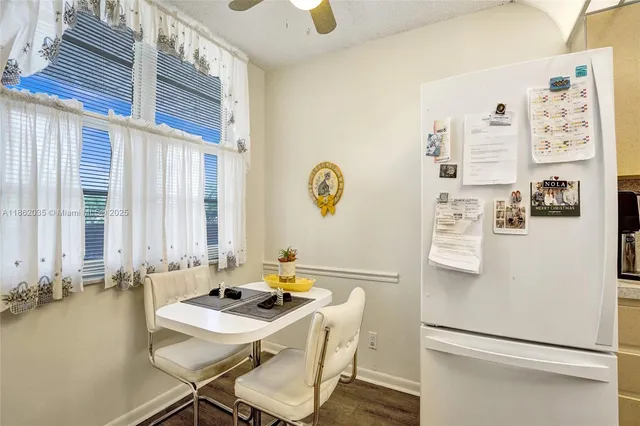 a room with a refrigerator and a table