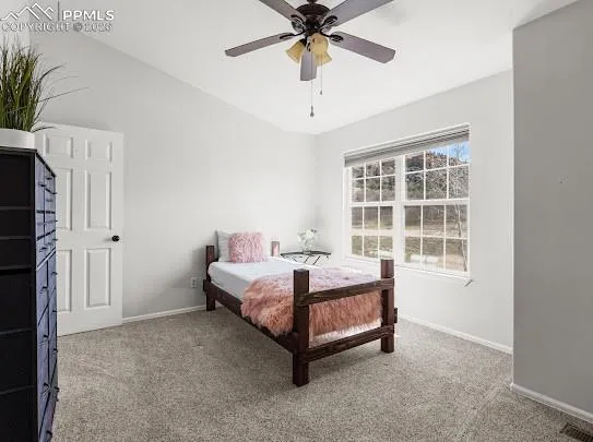 a bed room with a bed and a window